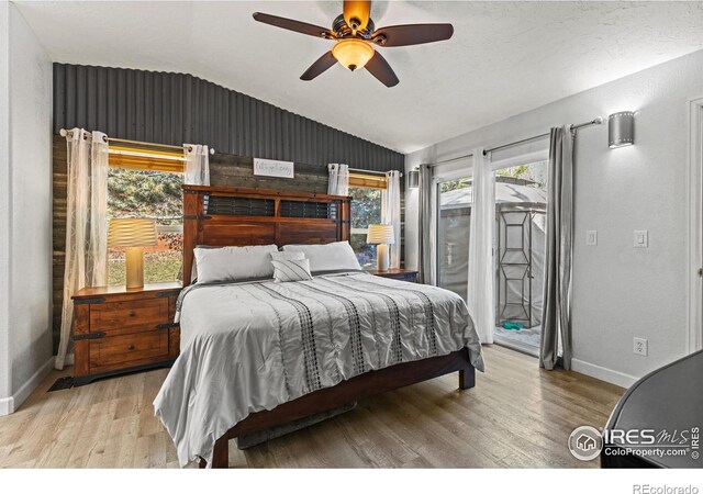 5621 W 27th St, Greeley, CO 80634 - bedroom with access to exterior, ceiling fan, baseboards, lofted ceiling, and wood finished floors