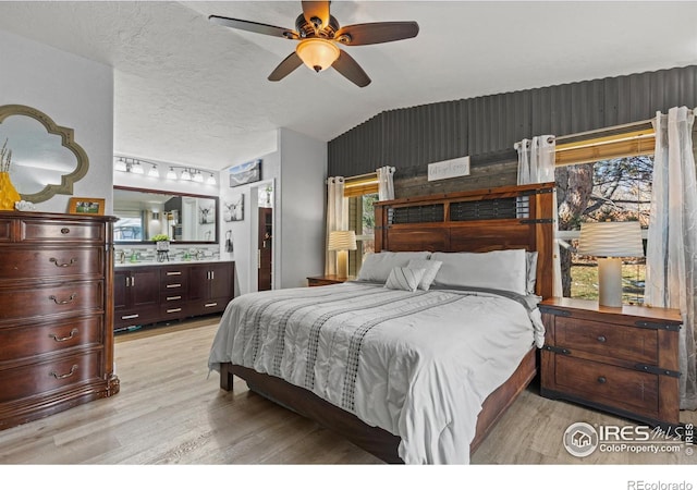 5621 W 27th St, Greeley, CO 80634 - bedroom with multiple windows, a textured ceiling, light wood-type flooring, and lofted ceiling