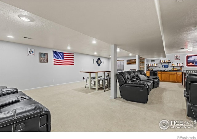 5621 W 27th St, Greeley, CO 80634 - living area with visible vents, indoor bar, light carpet, recessed lighting, and a textured ceiling
