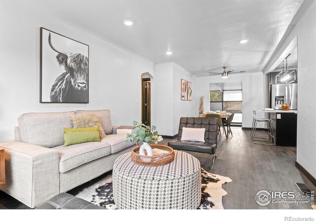 living room with ceiling fan, arched walkways, wood finished floors, and recessed lighting