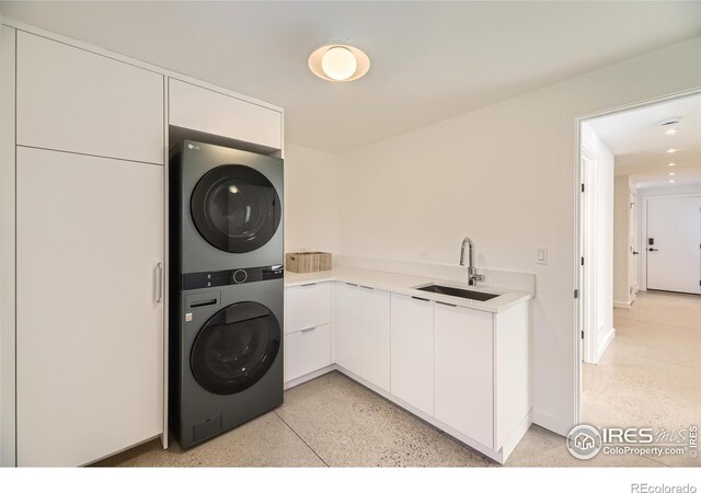 1580 Moss Rock Pl, Boulder, CO 80304 - laundry area featuring estacked washer and dryer and cabinet space