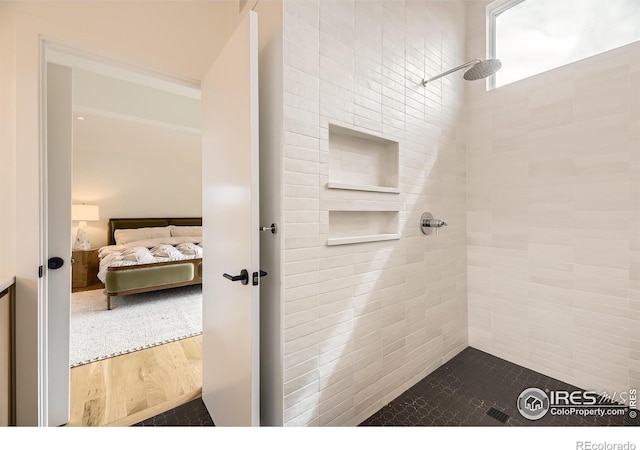 1580 Moss Rock Pl, Boulder, CO 80304 - ensuite bathroom featuring tiled shower and wood finished floors