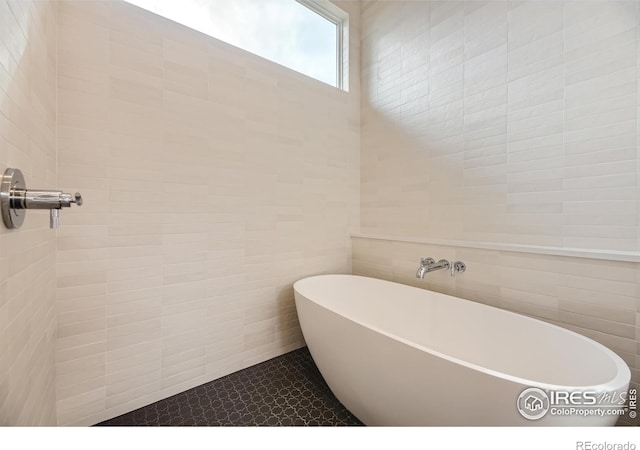 1580 Moss Rock Pl, Boulder, CO 80304 - full bath with a soaking tub, tile walls, and tile patterned floors