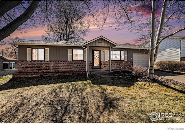 single story home with brick siding, board and batten siding, concrete driveway, a lawn, and an attached garage
