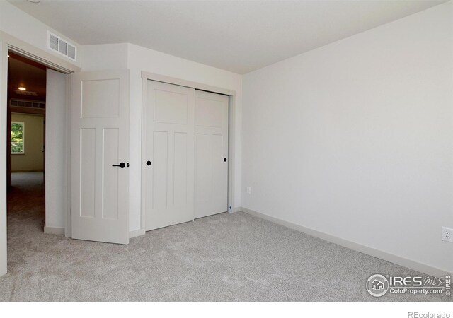 1047 Spartan Ave, Berthoud, CO 80513 - unfurnished bedroom featuring a closet, visible vents, baseboards, and carpet