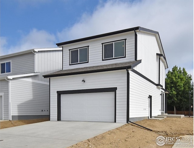 1047 Spartan Ave, Berthoud, CO 80513 - view of front facade with entry steps, a garage, and driveway