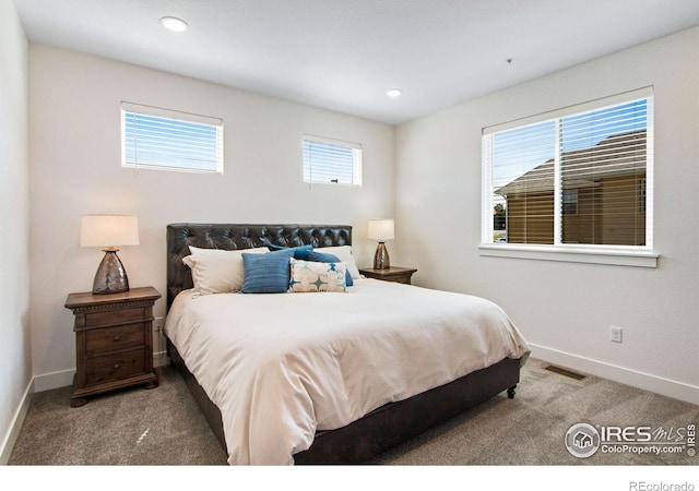 carpeted bedroom with recessed lighting, visible vents, multiple windows, and baseboards
