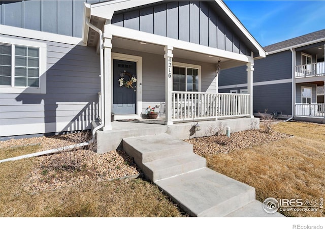 entrance to property featuring a porch and board and batten siding