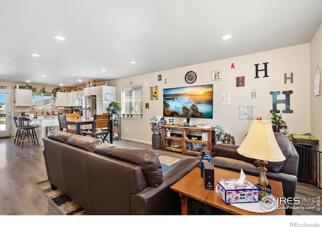 living room with recessed lighting, wood finished floors, and baseboards