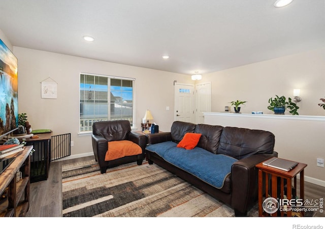 living room featuring recessed lighting, wood finished floors, and baseboards
