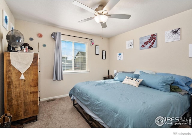 bedroom featuring visible vents, baseboards, ceiling fan, and carpet flooring