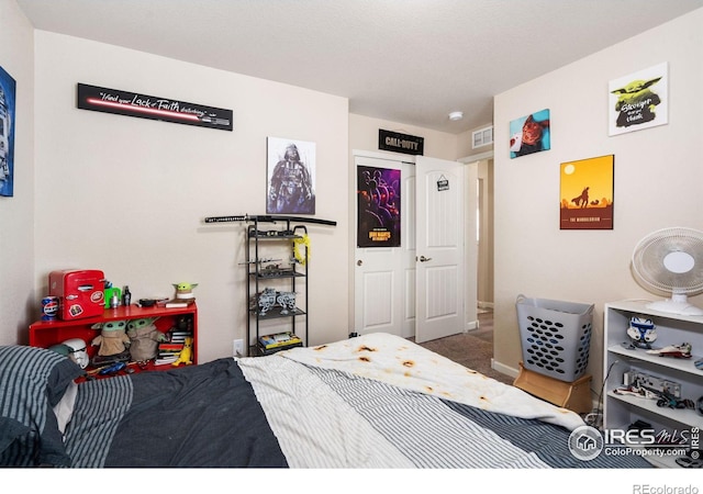 bedroom with carpet flooring and visible vents