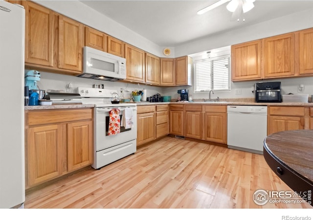 562 E St, Hillrose, CO 80733 - kitchen featuring light wood-type flooring, white appliances, light countertops, a ceiling fan, and a sink