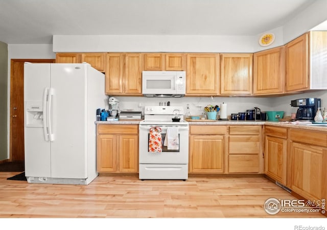 562 E St, Hillrose, CO 80733 - kitchen with white appliances, light wood-style floors, and light countertops