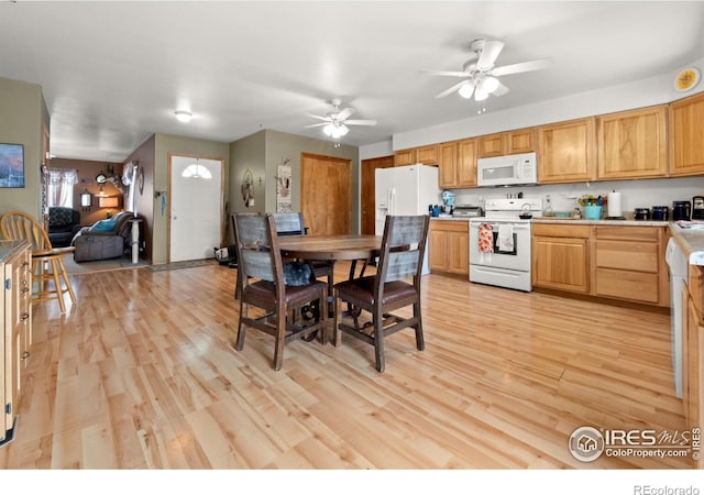 562 E St, Hillrose, CO 80733 - kitchen with a ceiling fan, light countertops, white appliances, and light wood-style flooring