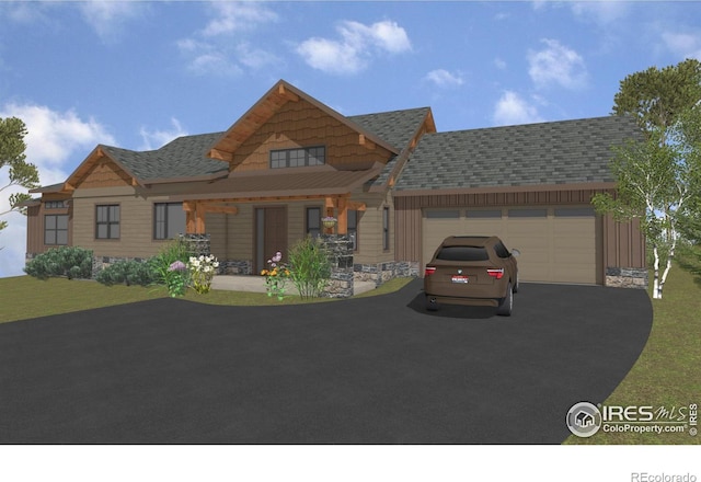 1680 Continental Peaks Cir, Estes Park, CO 80517 - view of front of house featuring stone siding, driveway, an attached garage, and a front yard