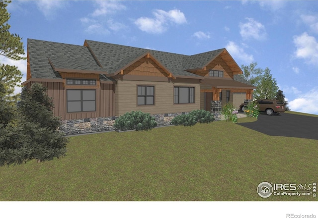 1680 Continental Peaks Cir, Estes Park, CO 80517 - view of front of house with board and batten siding, a front lawn, aphalt driveway, roof with shingles, and an attached garage