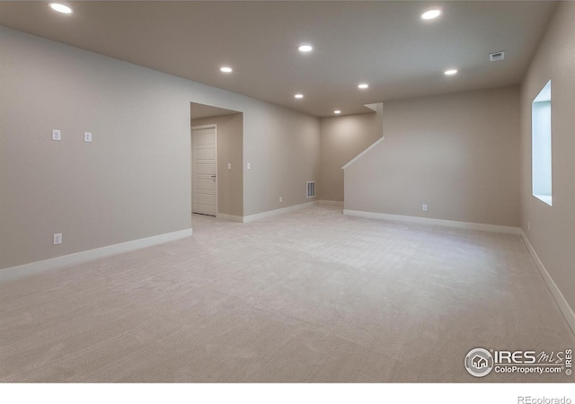 below grade area with recessed lighting, visible vents, and light colored carpet