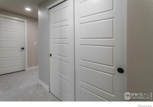 details with carpet, baseboards, and a textured wall