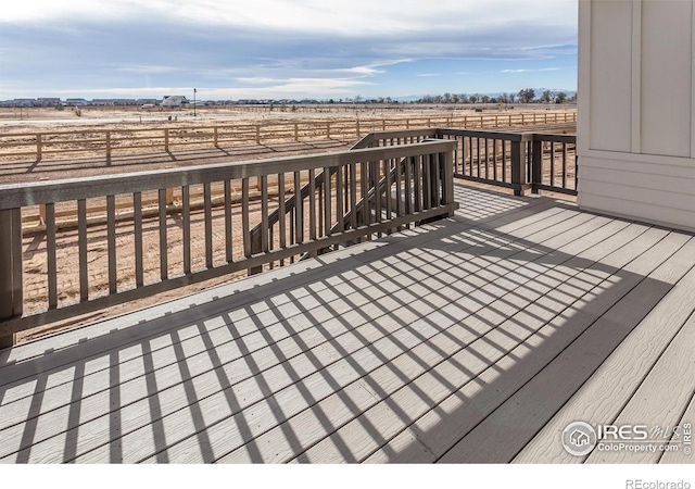 wooden deck with a rural view