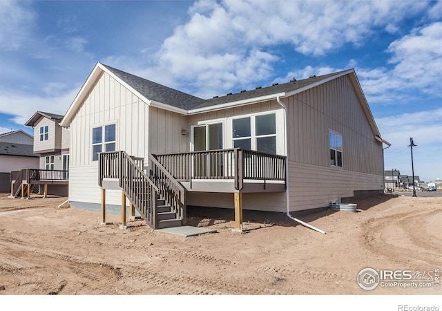 back of property with a wooden deck