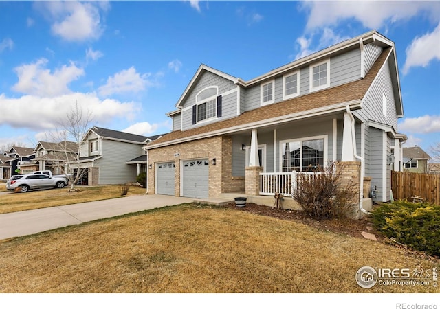 view of front of house with a front lawn, driveway, a porch, a garage, and brick siding