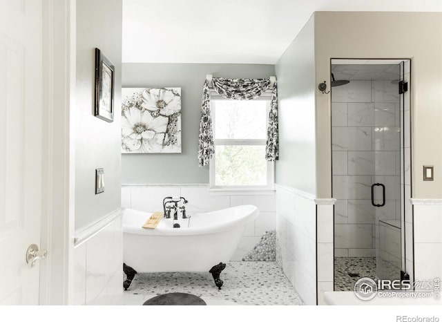 12023 Coal Creek Heights Dr, Golden, CO 80403 - bathroom featuring a shower stall, wainscoting, and a freestanding tub