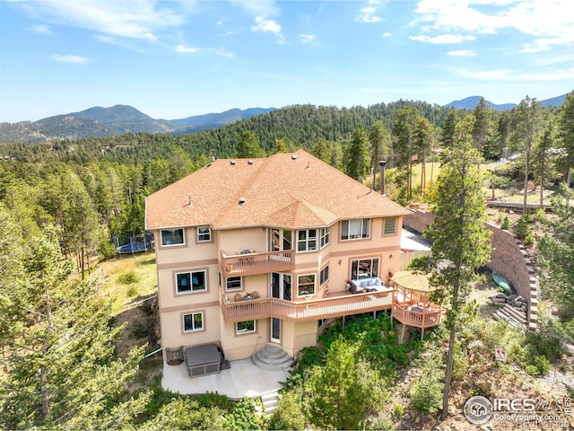 12023 Coal Creek Heights Dr, Golden, CO 80403 - drone / aerial view featuring a wooded view and a mountain view