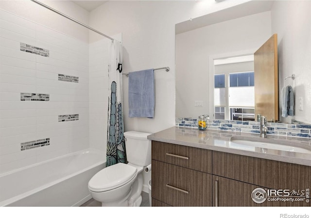 bathroom with backsplash, toilet, vanity, and shower / bathtub combination with curtain