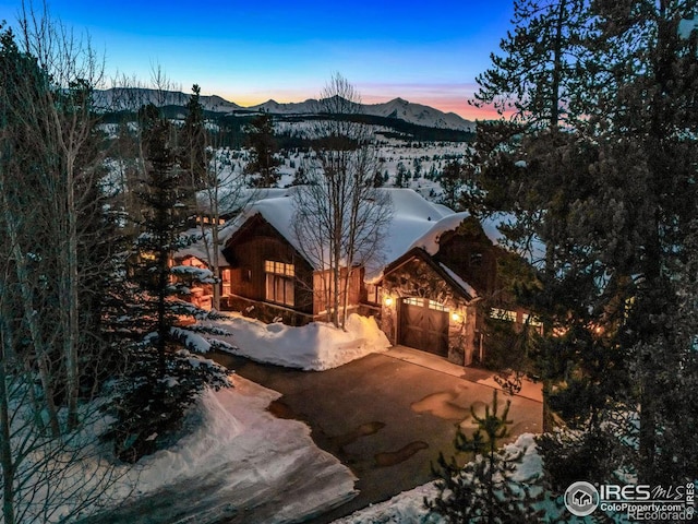 view of front of house featuring a mountain view, a garage, and driveway