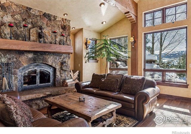 living room with baseboards, vaulted ceiling, recessed lighting, a fireplace, and wood finished floors