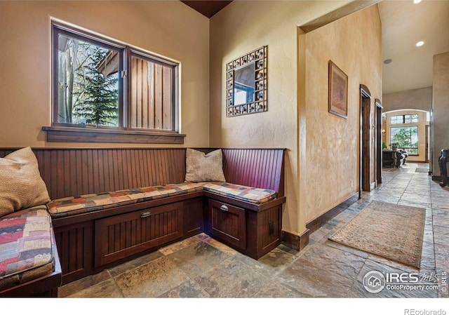 office featuring stone tile flooring, recessed lighting, baseboards, and a textured wall