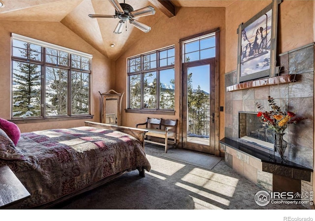 carpeted bedroom with beamed ceiling, high vaulted ceiling, a tiled fireplace, and access to outside