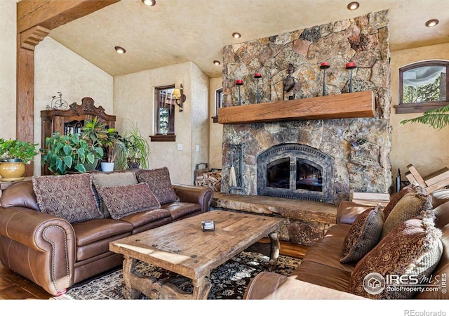 living room with lofted ceiling, recessed lighting, and a fireplace