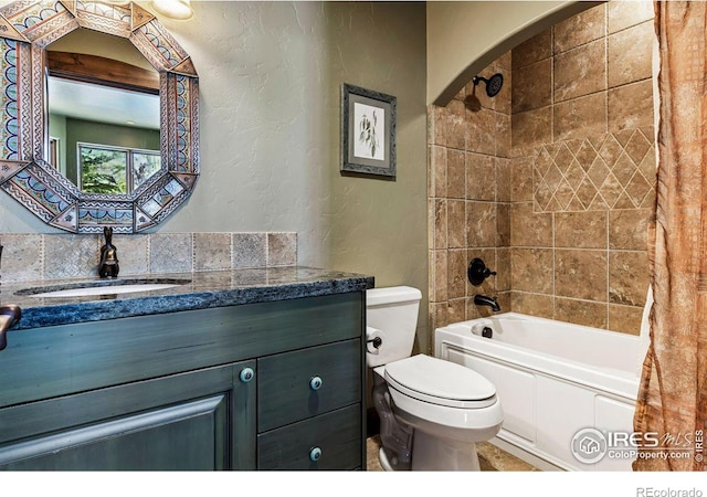 full bathroom with vanity, toilet, a textured wall, and shower / bath combo with shower curtain