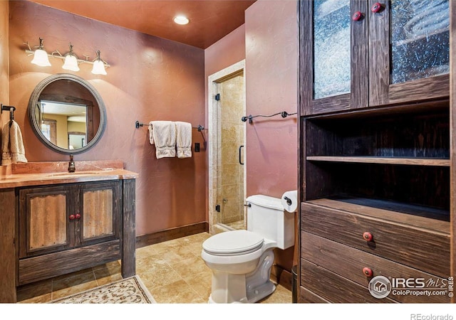 bathroom with vanity, recessed lighting, a stall shower, tile patterned flooring, and toilet