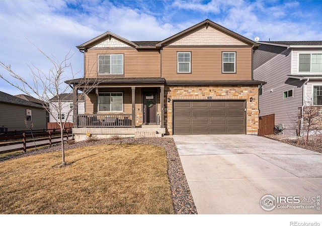 254 Ptarmigan Ln, Johnstown, CO 80534 - craftsman-style home with a porch, concrete driveway, a garage, and stone siding