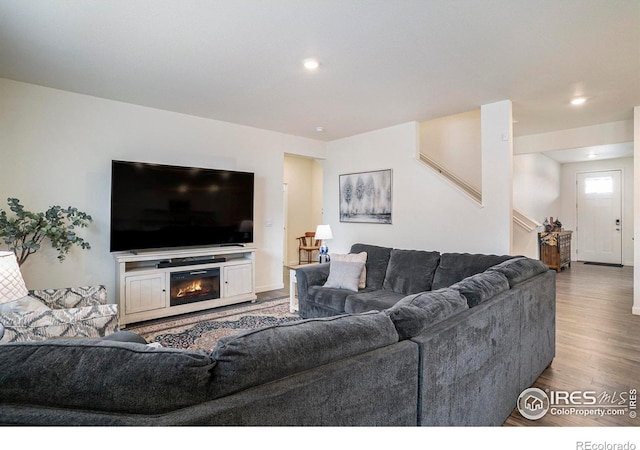 254 Ptarmigan Ln, Johnstown, CO 80534 - living room featuring wood finished floors, recessed lighting, and a glass covered fireplace