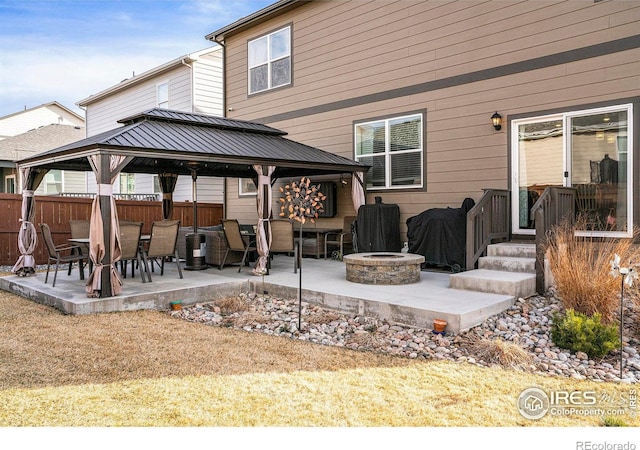 254 Ptarmigan Ln, Johnstown, CO 80534 - rear view of house featuring a gazebo, an outdoor fire pit, a patio area, and a metal roof