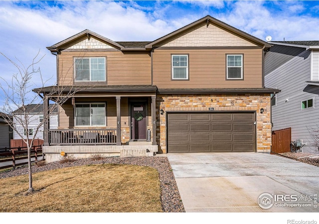 254 Ptarmigan Ln, Johnstown, CO 80534 - craftsman house with a porch, concrete driveway, an attached garage, and stone siding
