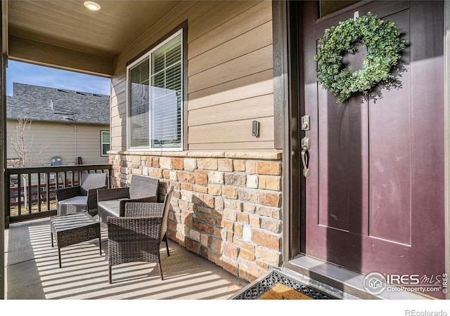 254 Ptarmigan Ln, Johnstown, CO 80534 - property entrance with a porch and stone siding