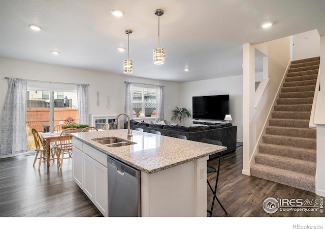 254 Ptarmigan Ln, Johnstown, CO 80534 - kitchen with dishwasher, white cabinetry, dark wood-style floors, light stone countertops, and a kitchen island with sink