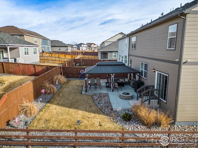 254 Ptarmigan Ln, Johnstown, CO 80534 - fenced backyard featuring a residential view, a gazebo, a patio area, and an outdoor living space with a fire pit