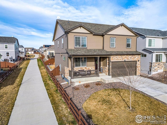 254 Ptarmigan Ln, Johnstown, CO 80534 - townhome / multi-family property featuring covered porch, driveway, a residential view, an attached garage, and a shingled roof
