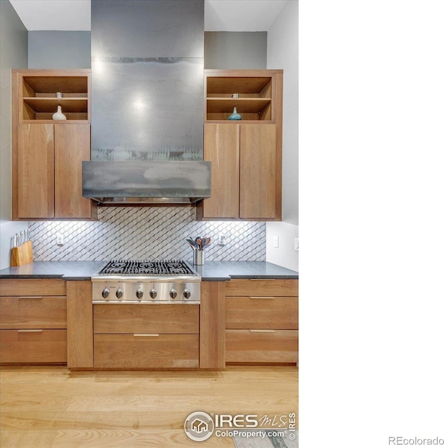 kitchen with open shelves, stainless steel gas cooktop, extractor fan, and decorative backsplash