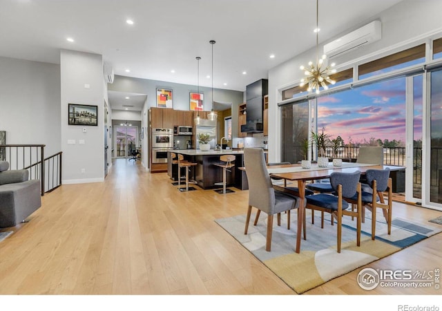 dining area featuring a wall mounted air conditioner, light wood finished floors, a chandelier, and recessed lighting