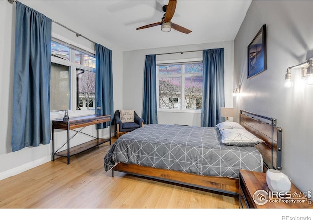 bedroom featuring wood finished floors and baseboards