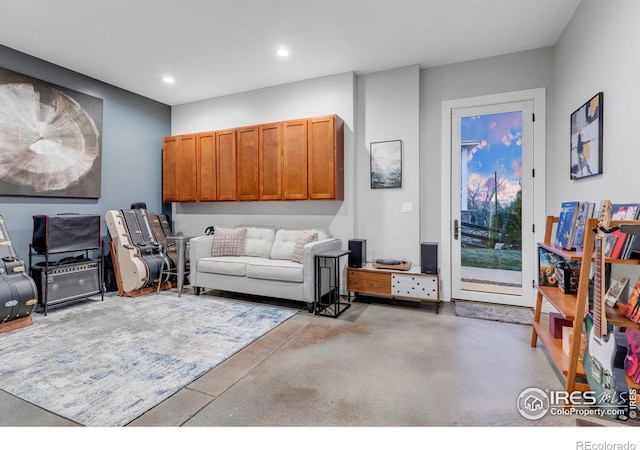 living area featuring recessed lighting and concrete floors