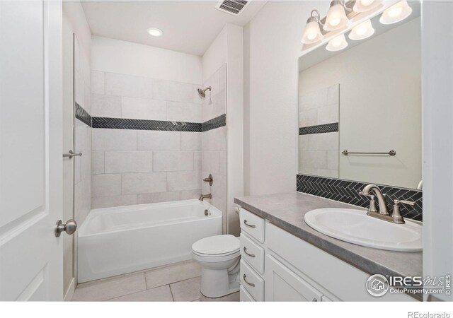 bathroom with visible vents, toilet, bathtub / shower combination, tile patterned floors, and vanity