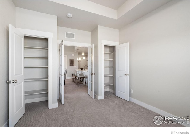 unfurnished bedroom with visible vents, baseboards, and carpet floors